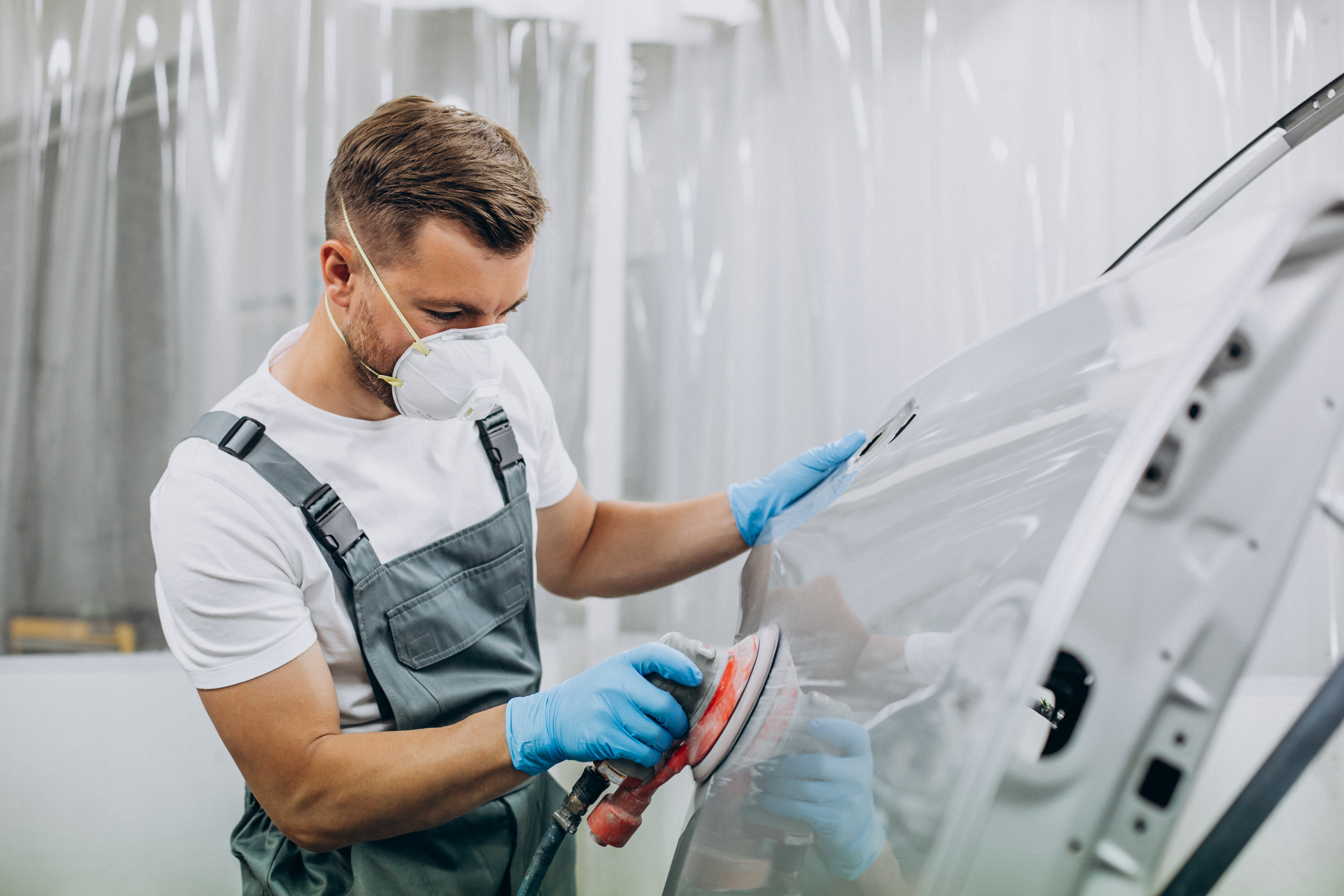 car-mechanic-polishing-car-before-painting.jpg