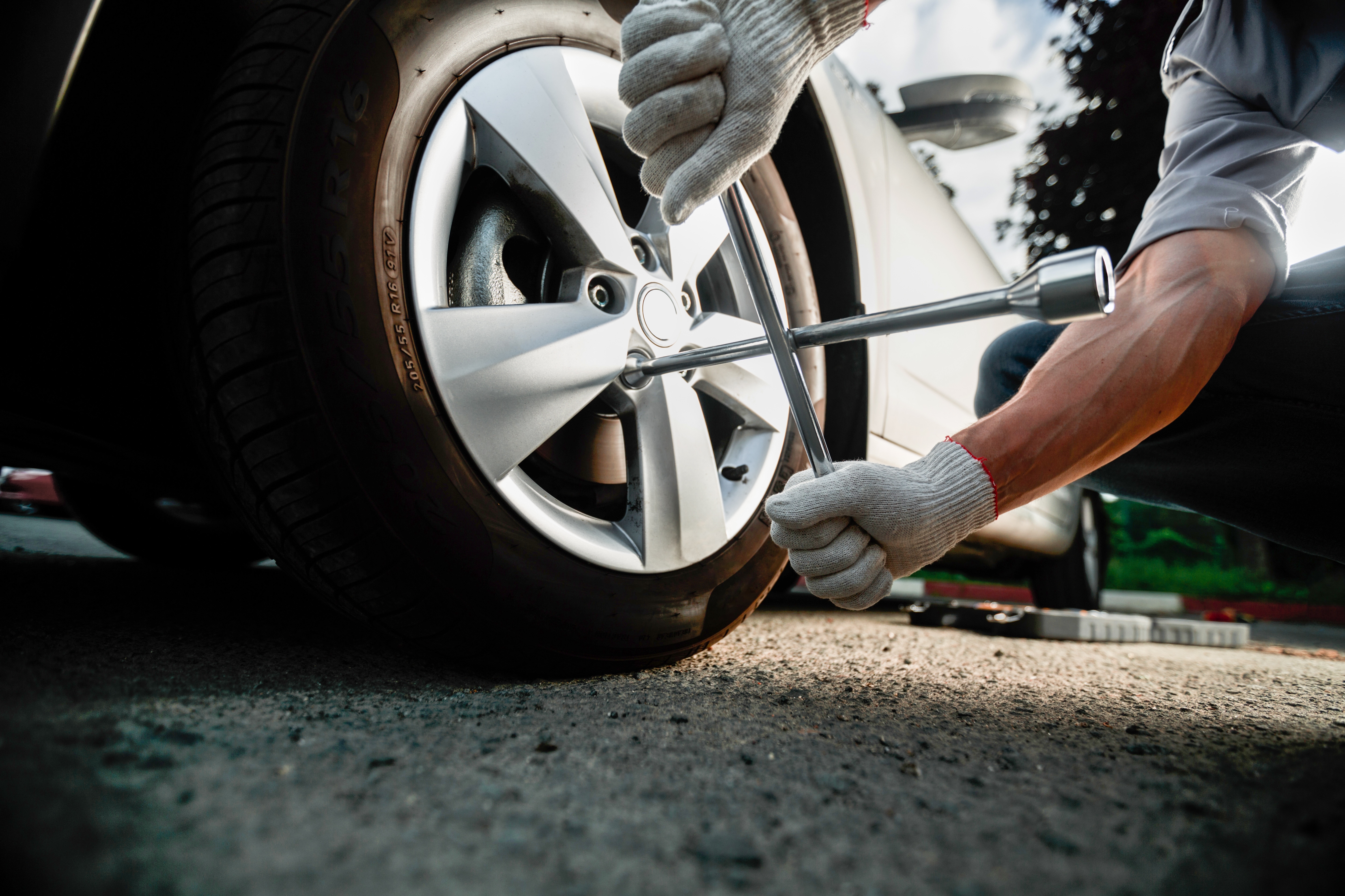 hand-mechanic-changing-wheels-tires-while-working-car-repair-center.jpg