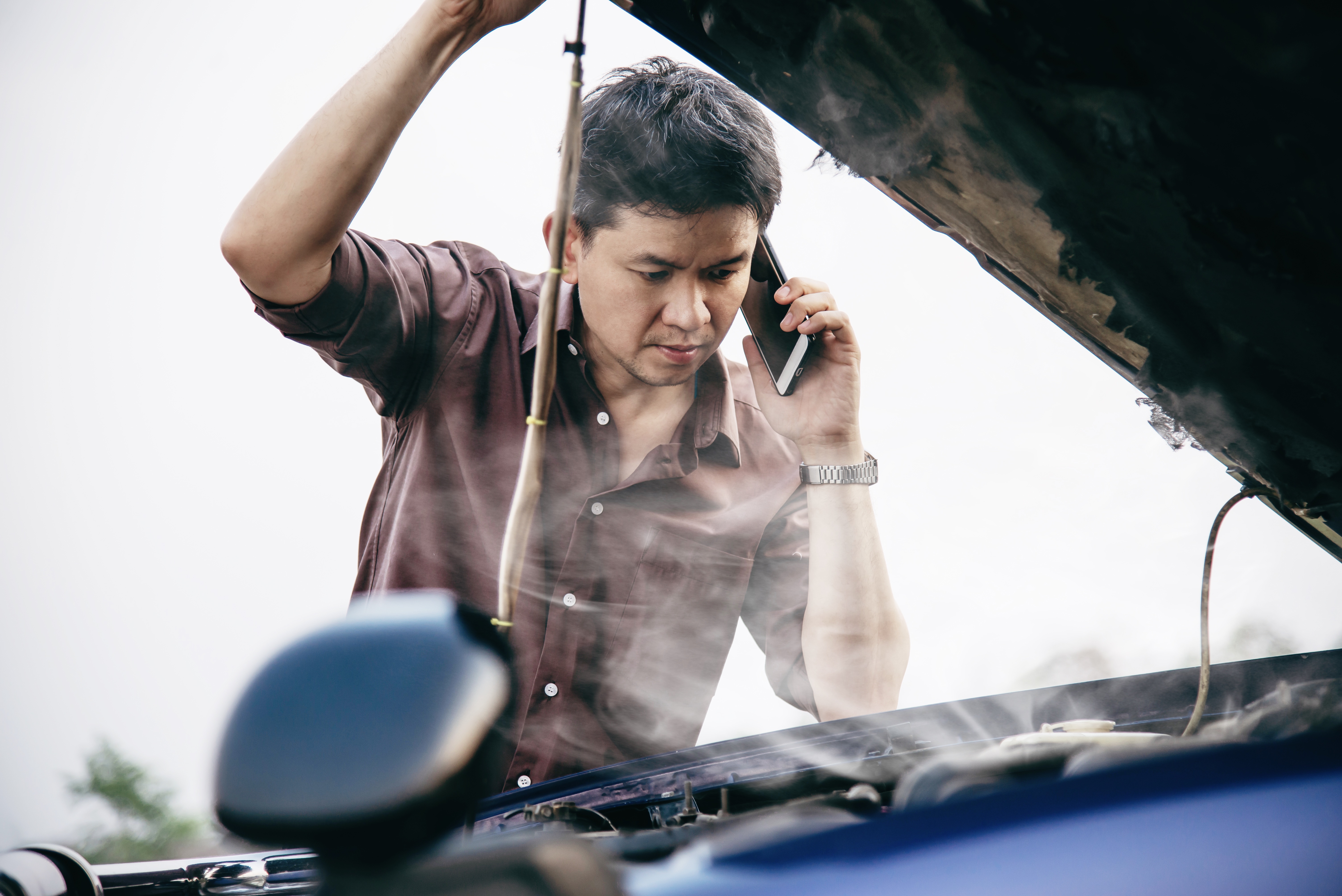 man-try-fix-car-engine-problem-local-road.jpg