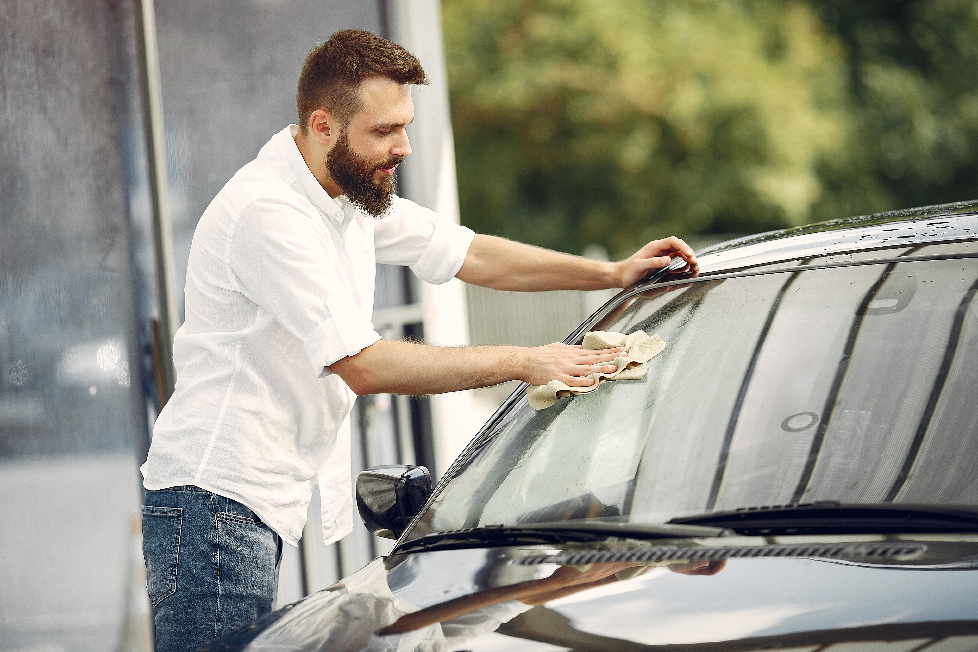man-white-shirt-wipes-car-car-wash.jpg