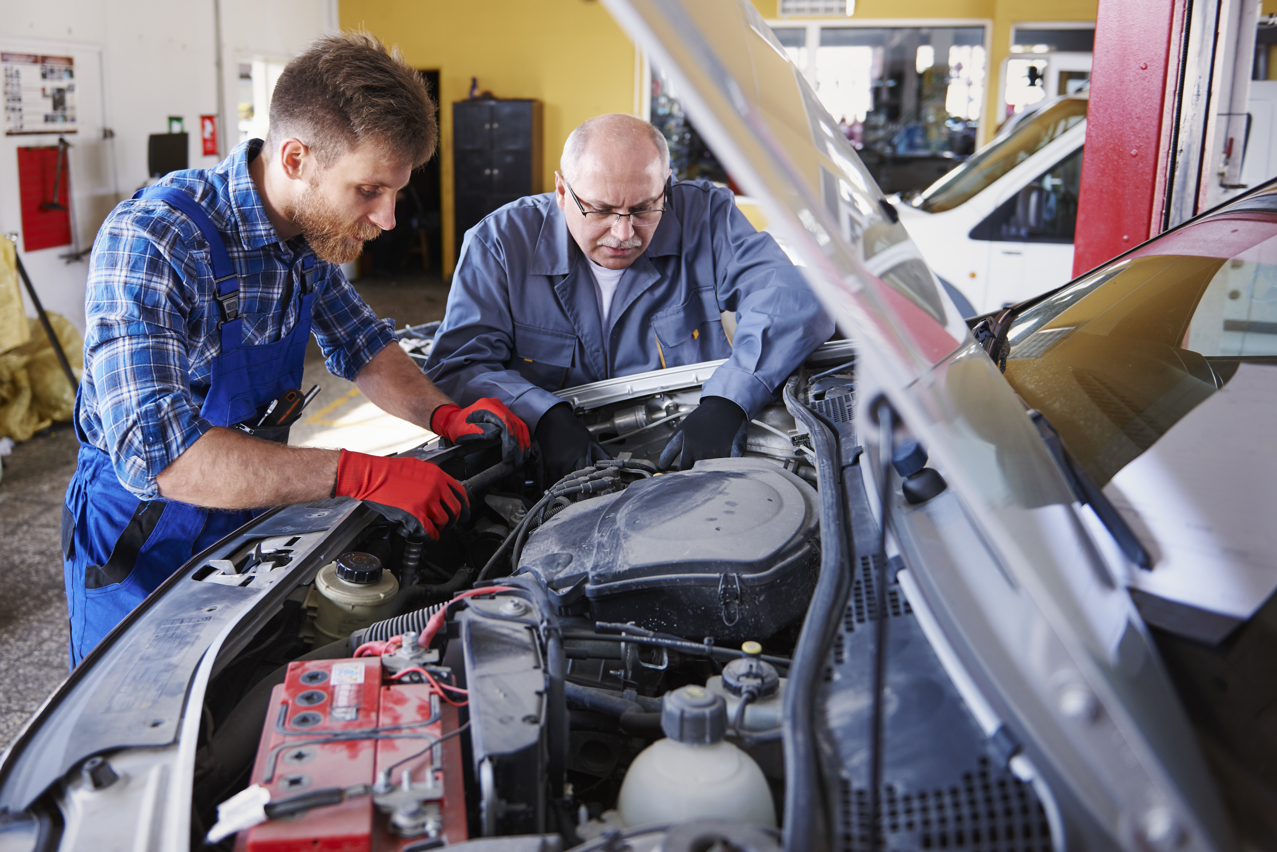 mechanics-repairing-car-workshop.jpg