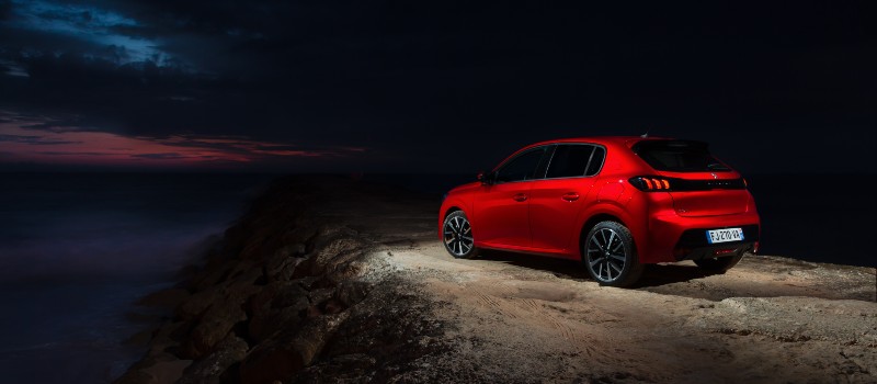 Peugeot 208 rouge electrique statique nuit