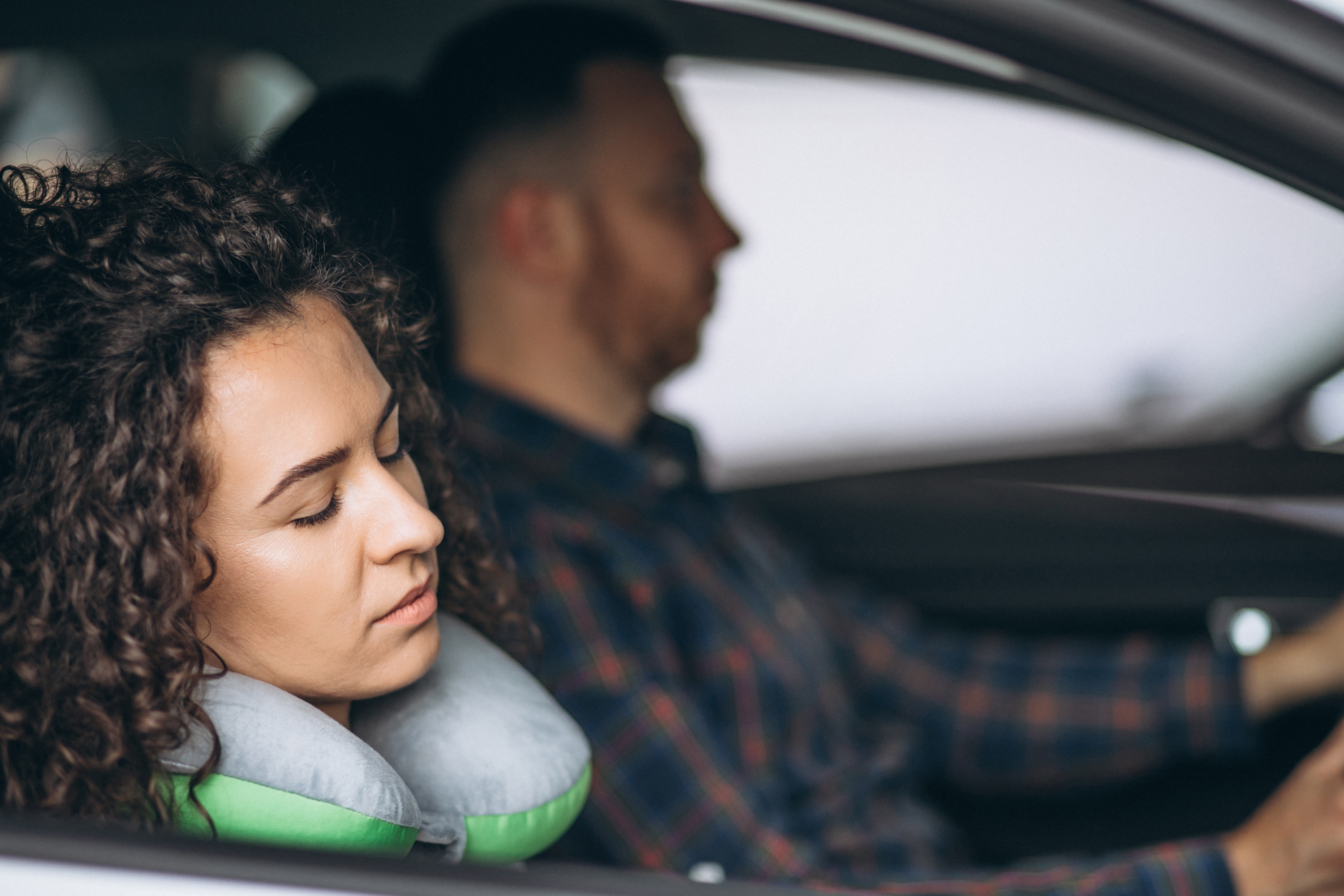 woman-sleeping-car-car-pillow.jpg