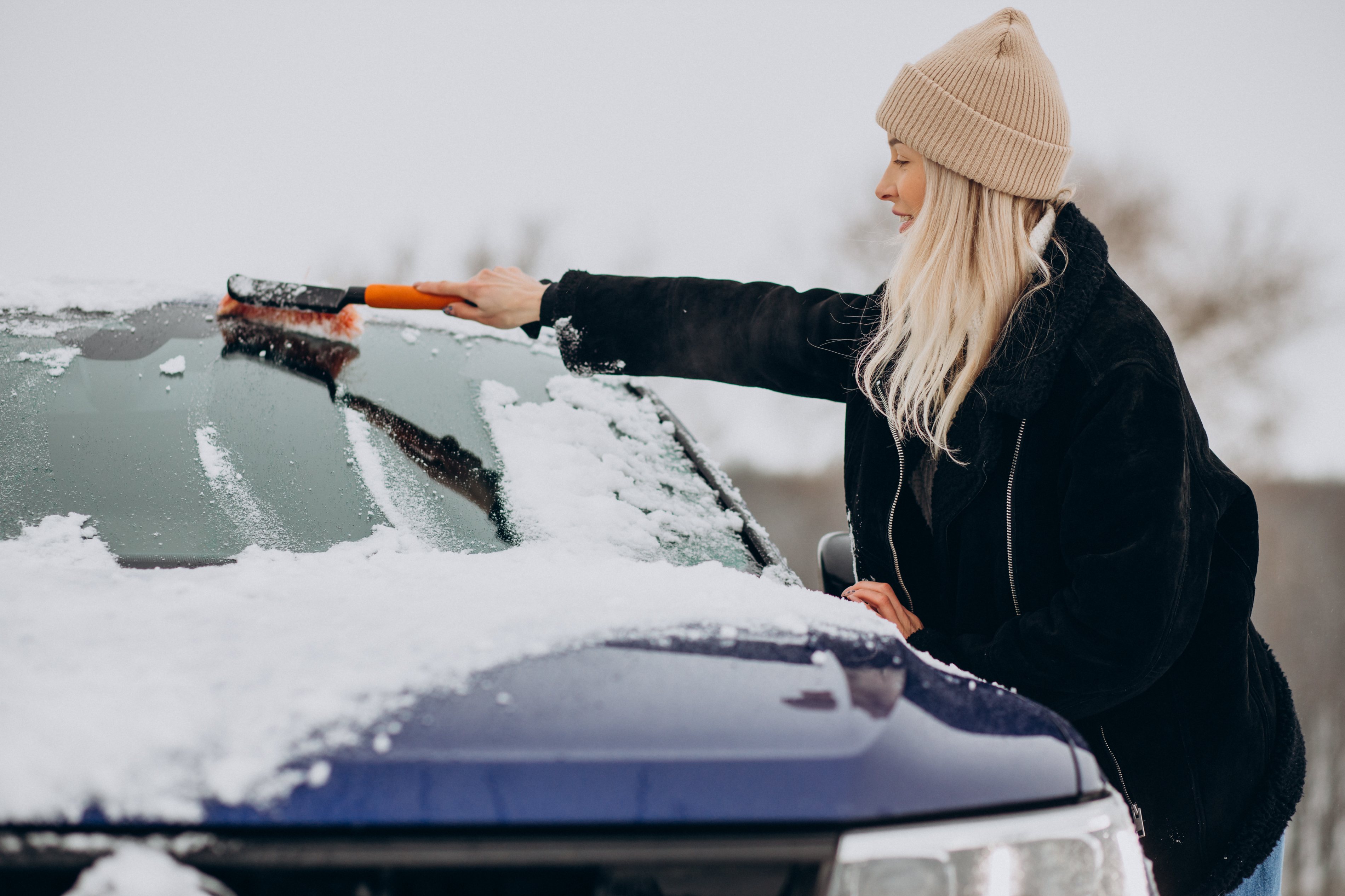 woman-cleaning-her-window-car-from-snow.jpg